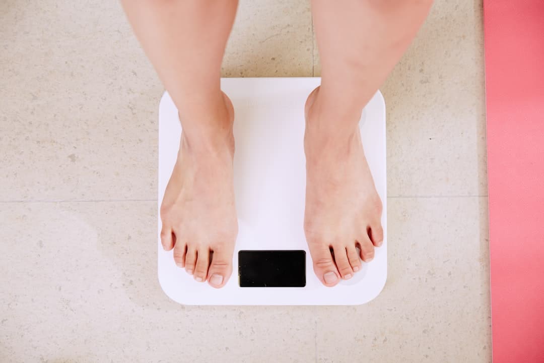 Person standing on a white digital bathroom scale